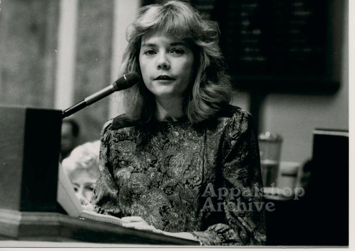 Production still of Belinda Ann Mason at mic