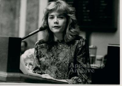 Production still of Belinda Ann Mason at mic