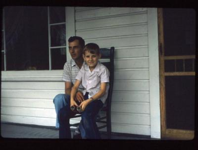 Father and son sitting on porch