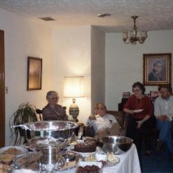 Family sitting around a buffet table