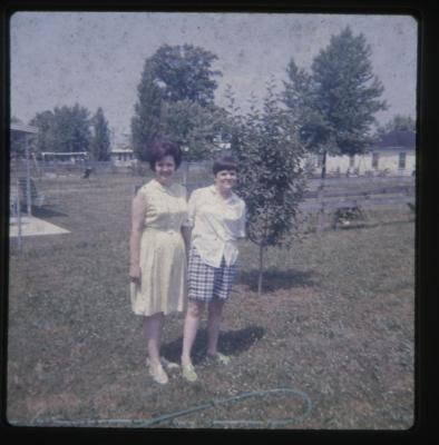 Two women standing in a yard