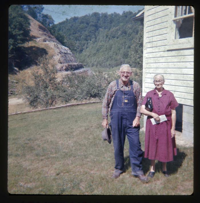 Man and woman standing in front of house