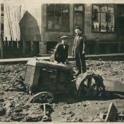 Two men with tractor stuck in mud. Neon, KY, 1924