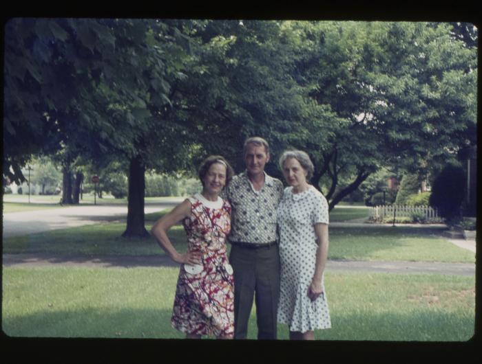 Two women and a man standing outdoors