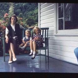 Woman and two children on porch bench