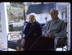 Man and woman sitting on porch bench