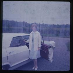 Woman standing beside car