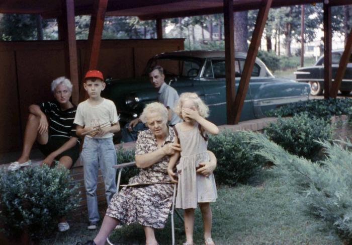 Exterior of family beside carport