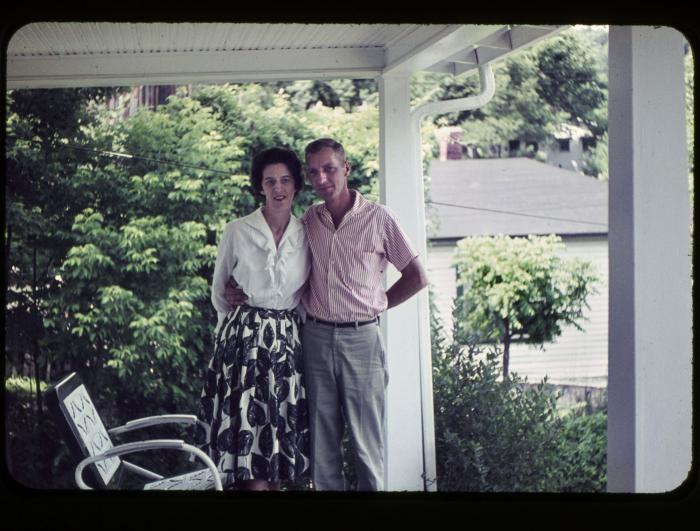 Man and woman standing together on front porch