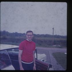 Man standing in front of open car door