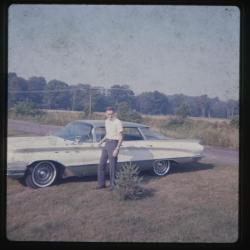 Man standing beside car