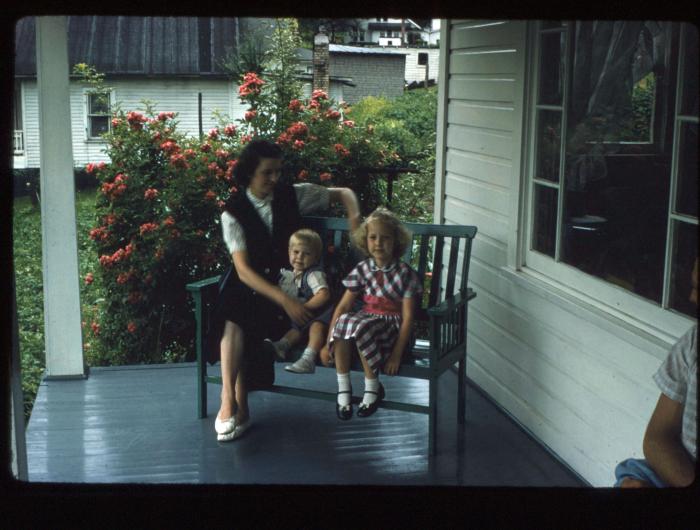 Woman and children sitting on a porch