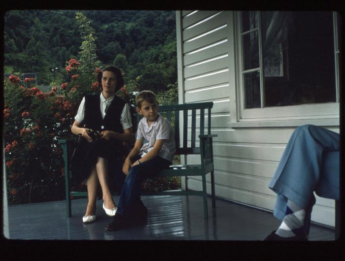 Mother and son sitting on porch