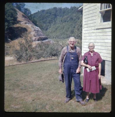 Man and woman standing in front of house