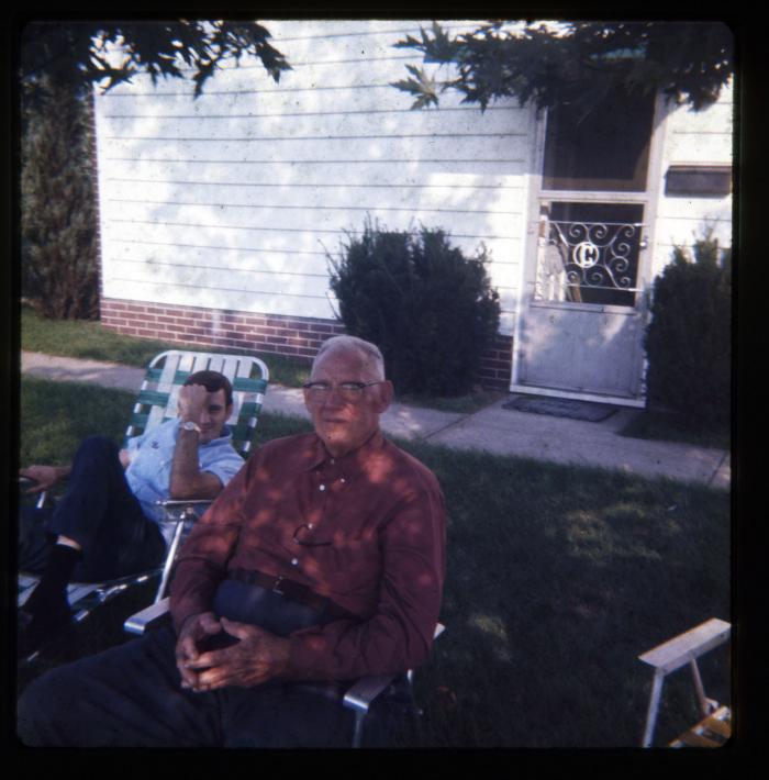 Two men sitting in lawn chairs