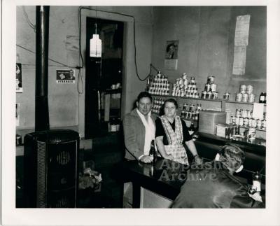 Man and woman standing behind a store counter