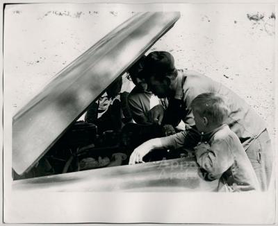 Production still of men under car hood - The Struggle of Coon Branch Mountain