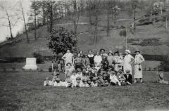 Group of adults and children posing for photo in Jenkins park