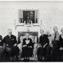 Group of people sitting in front of fireplace