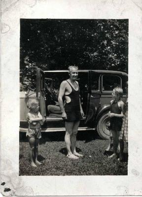 Man and children in front of car