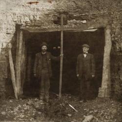Two men in front of a coal mine