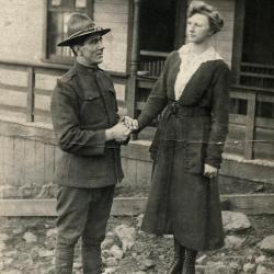 Exterior of man in WWI uniform holding woman's hand