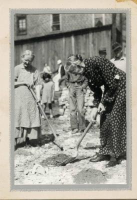 Woman using shovel at groundbreaking