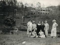 Group of women posing outdoors with a building in the background