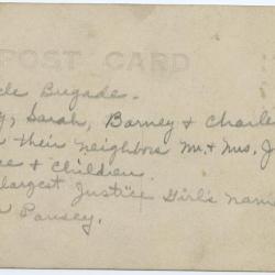 Group of children and adults standing next to bicycles