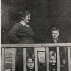 Woman and three children on a porch
