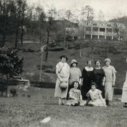 Group of women posing outdoors with a building in the background