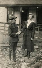 Exterior of man in WWI uniform holding woman's hand