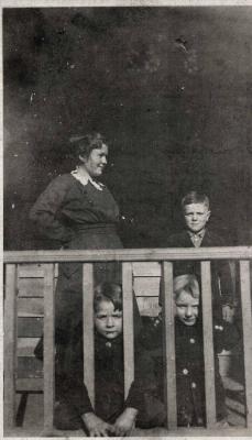 Woman and three children on a porch