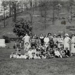 Group of adults and children posing for photo in Jenkins park