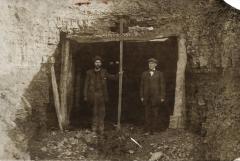 Two men in front of a coal mine