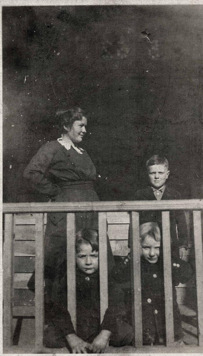 Woman and three children on a porch