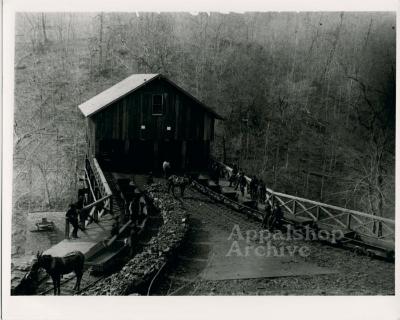 Wooden coal tipple with cars