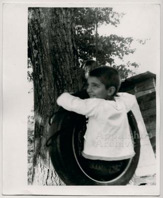 Production still of boy in tire swing - The Struggle of Coon Branch Mountain