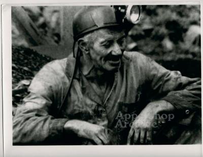 Frank Jackson in mining clothes and helmet.