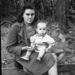 Woman posing for a photo with a child outdoors