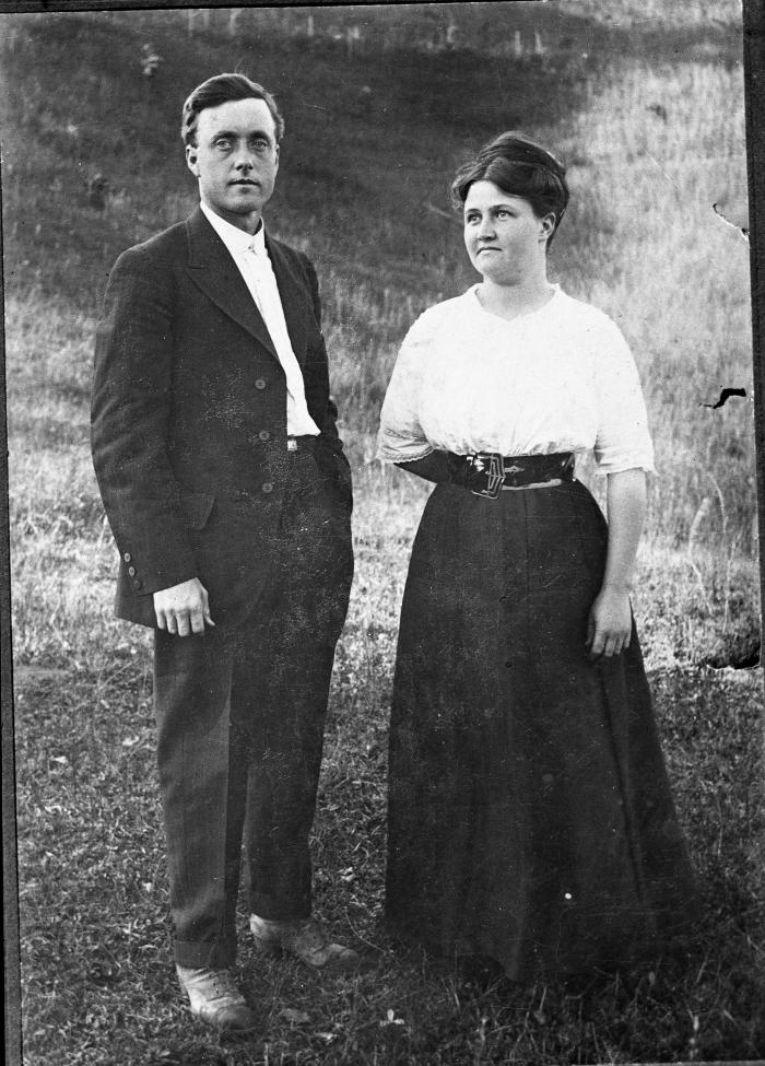 Man and woman posing for a photo outdoors