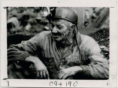 Coal miner in mining clothes and helmet