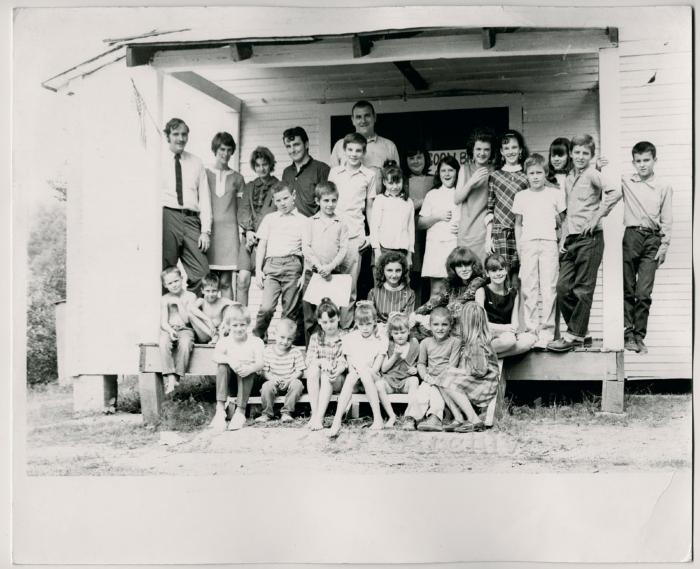 Production still of posed group of children and adults, exterior - The Struggle of Coon Branch Mountain