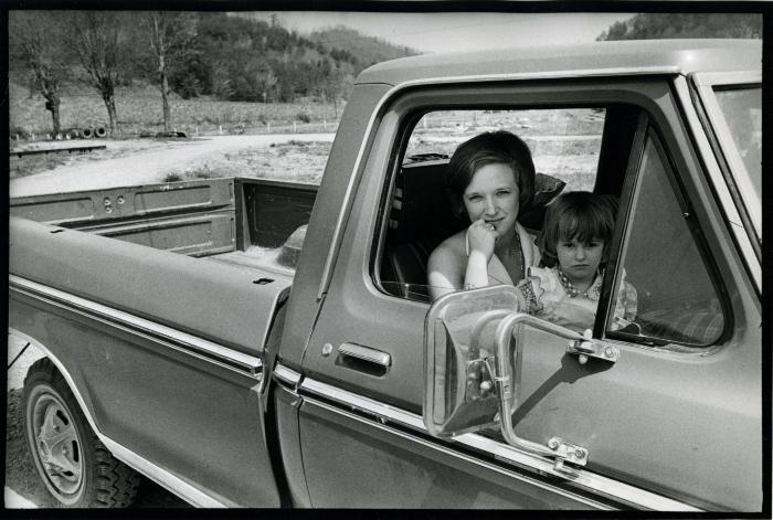 Woman and daughter in pickup truck