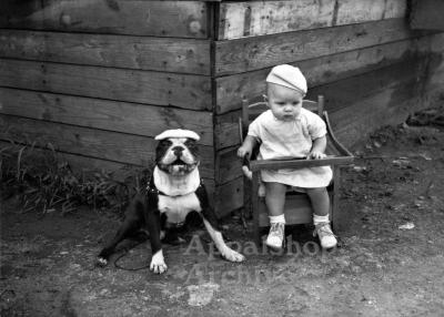 Toddler and dog, both wearing hats