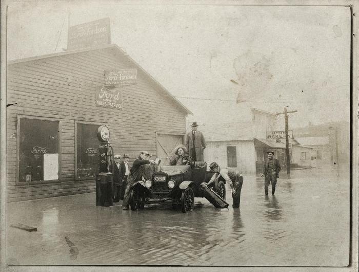 Car stuck on flooded street