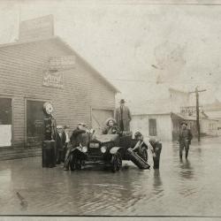 Car stuck on flooded street