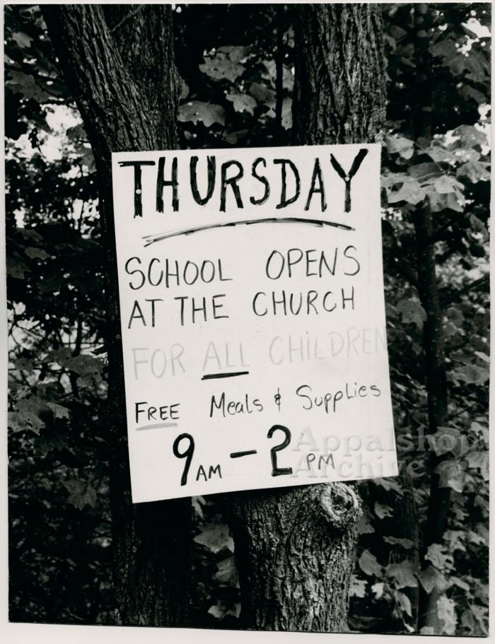 Production still of sign about meals for children - The Struggle of Coon Branch Mountain