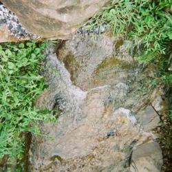 Water running down mountain rock