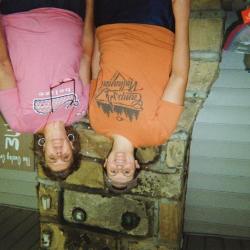Two women on porch, "The Owsley Crew" sign in background